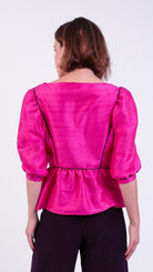 woman wearing VAAI pink silk peplum party top