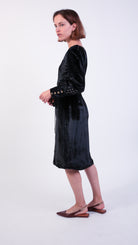 woman wearing VAAI black velvet dress with gold embroidery 