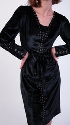 woman wearing VAAI black velvet dress with gold embroidery 