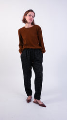 woman wearing VAAI black wool elasticated barrel leg trouser