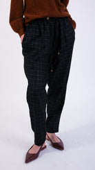 woman wearing VAAI black wool elasticated barrel leg trouser