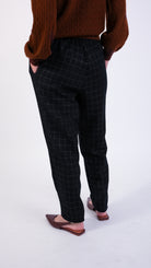 woman wearing VAAI black wool elasticated barrel leg trouser