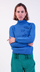 woman wearing VAAI blue floral polo jumper