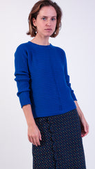 woman wearing VAAI blue ribbed wool jumper