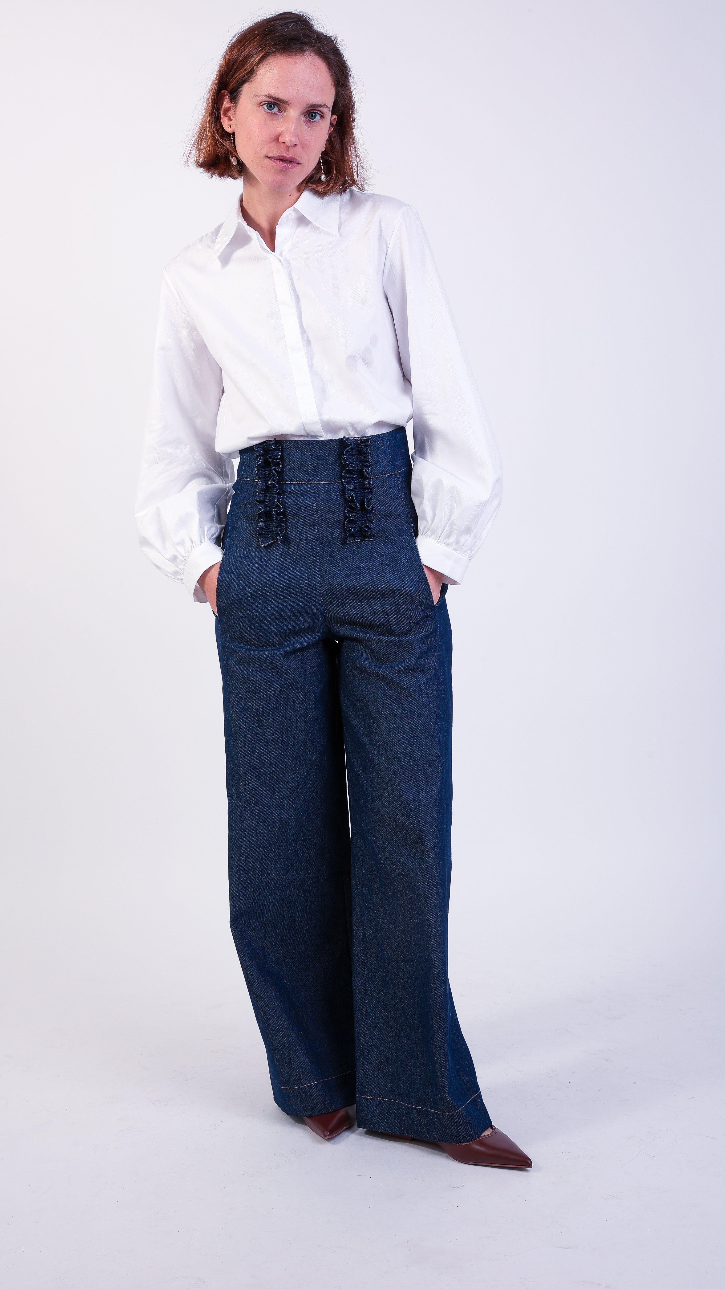 woman wearing VAAI high waisted tailored blue denim jeans