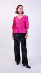 woman wearing VAAI pink silk peplum party top