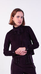 woman wearing VAAI aubergine corduroy ruffle top