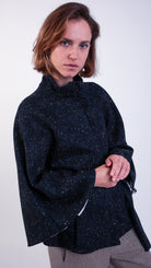 woman wearing VAAI scallop detail wool cape coat