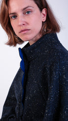 woman wearing VAAI scallop detail wool cape coat