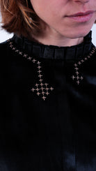 woman wearing black velvet gold cross stitch party top