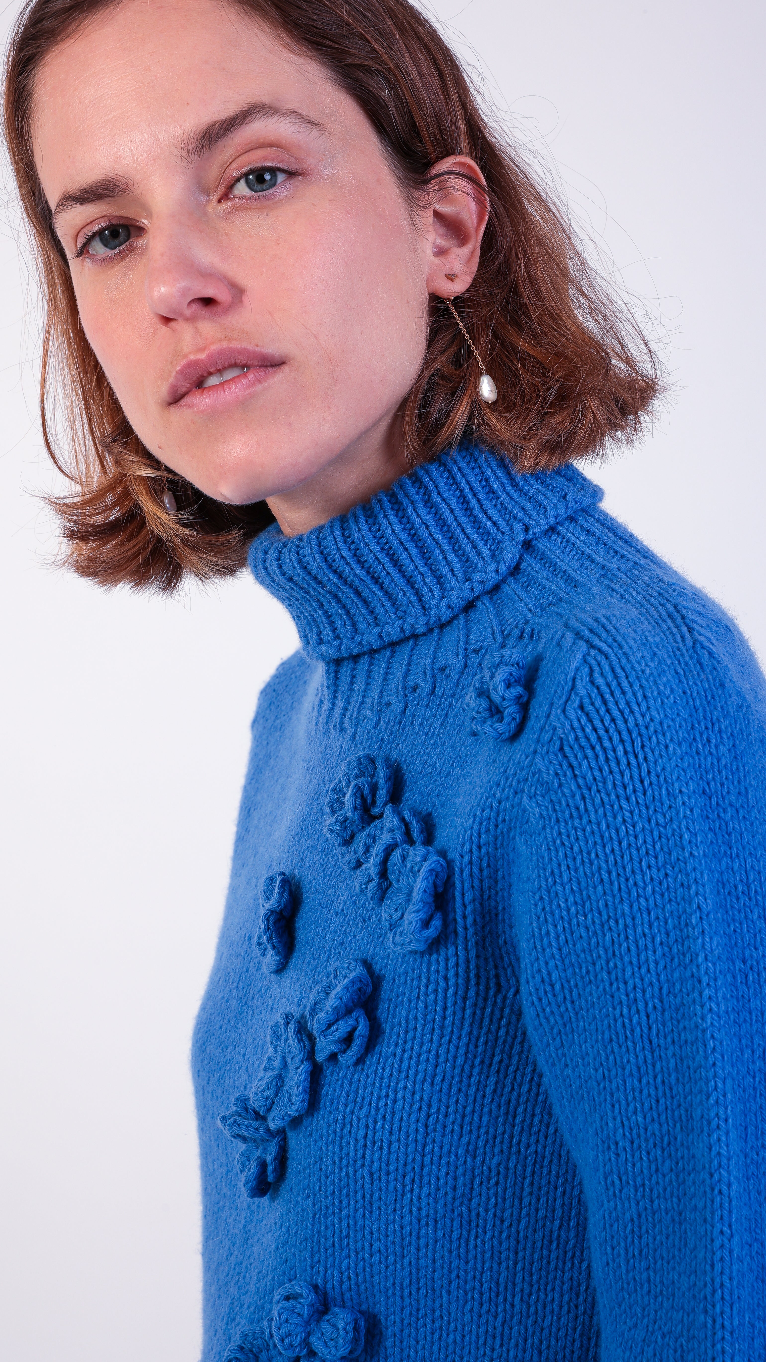 woman wearing VAAI blue floral polo jumper