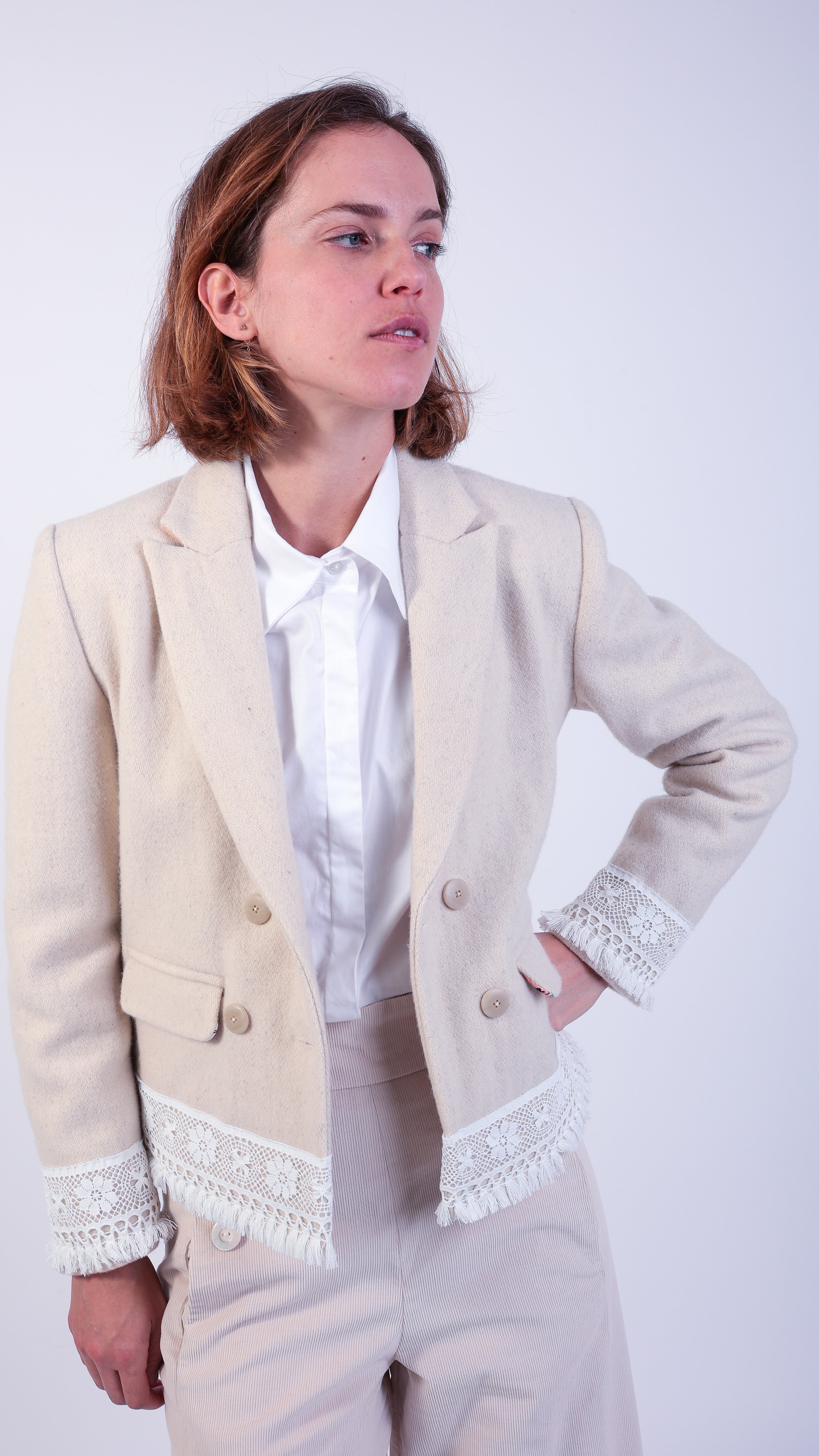 woman wearing VAAI double breasted ivory wool with lace