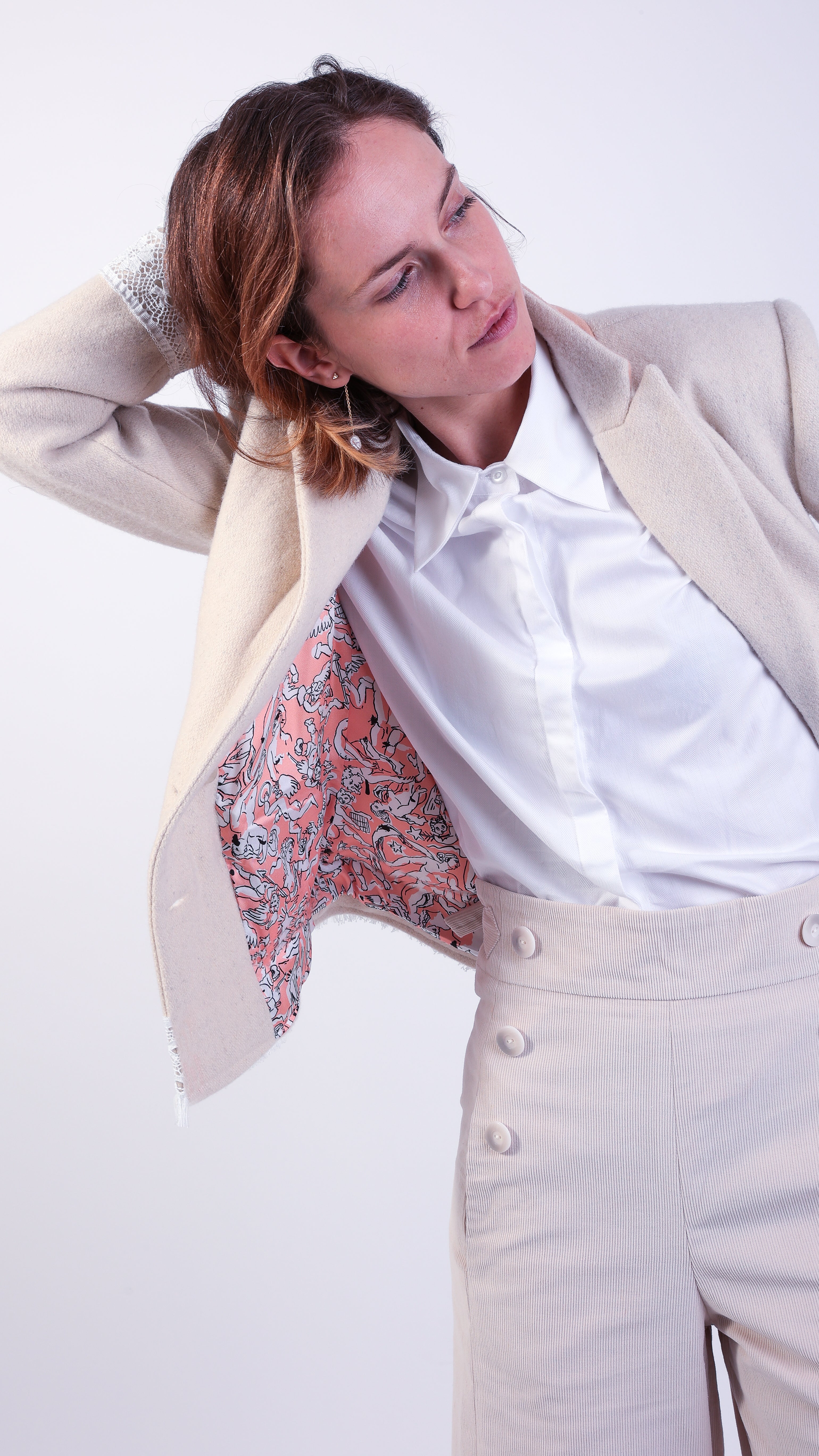 woman wearing VAAI double breasted ivory wool with lace