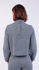 woman wearing VAAI blue herringbone ruffle top