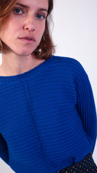 woman wearing VAAI blue ribbed wool jumper