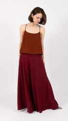 woman wearing VAAI burgundy silk maxi skirt