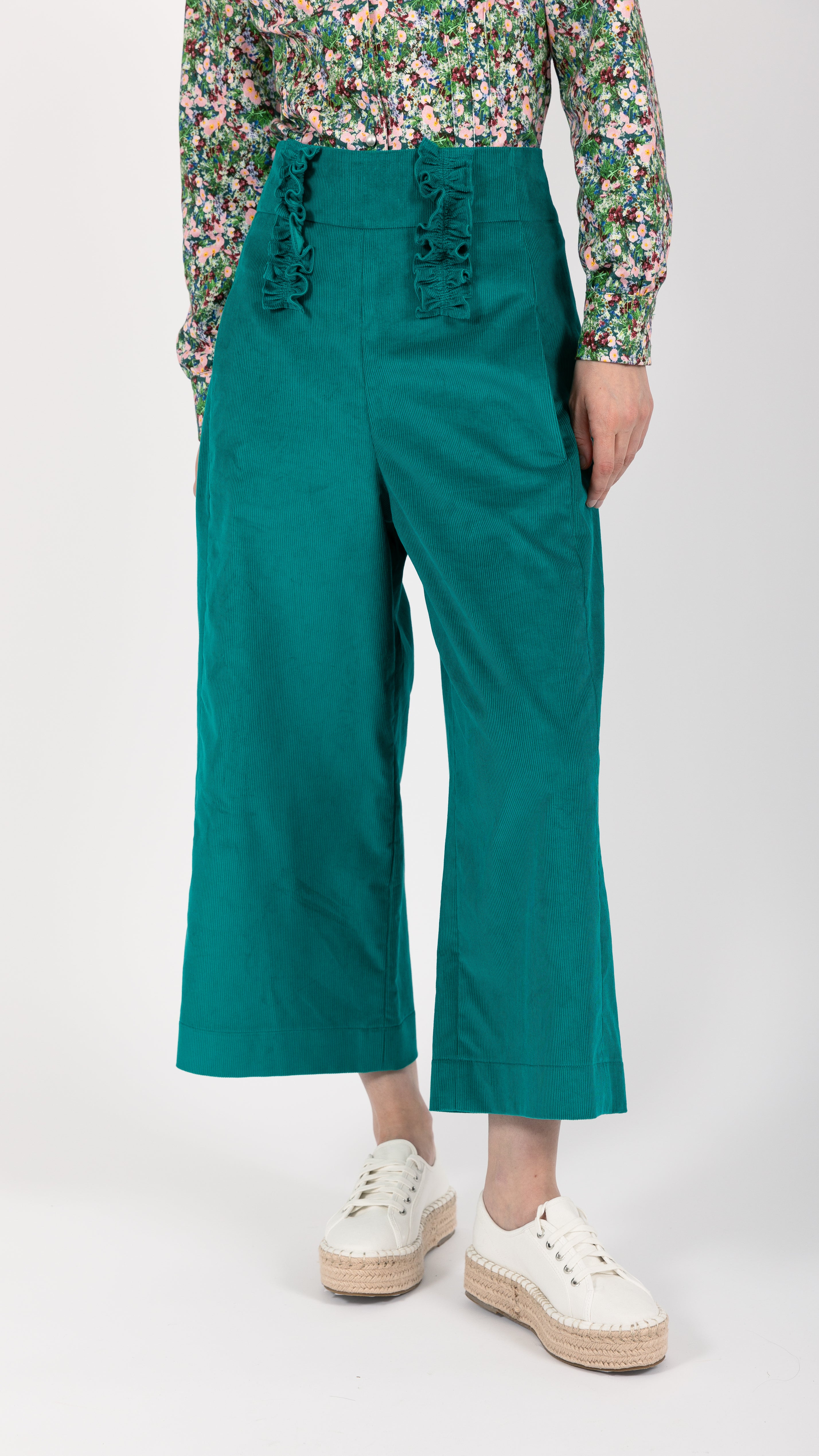 woman wearing VAAI green cropped high waisted ruffle pant