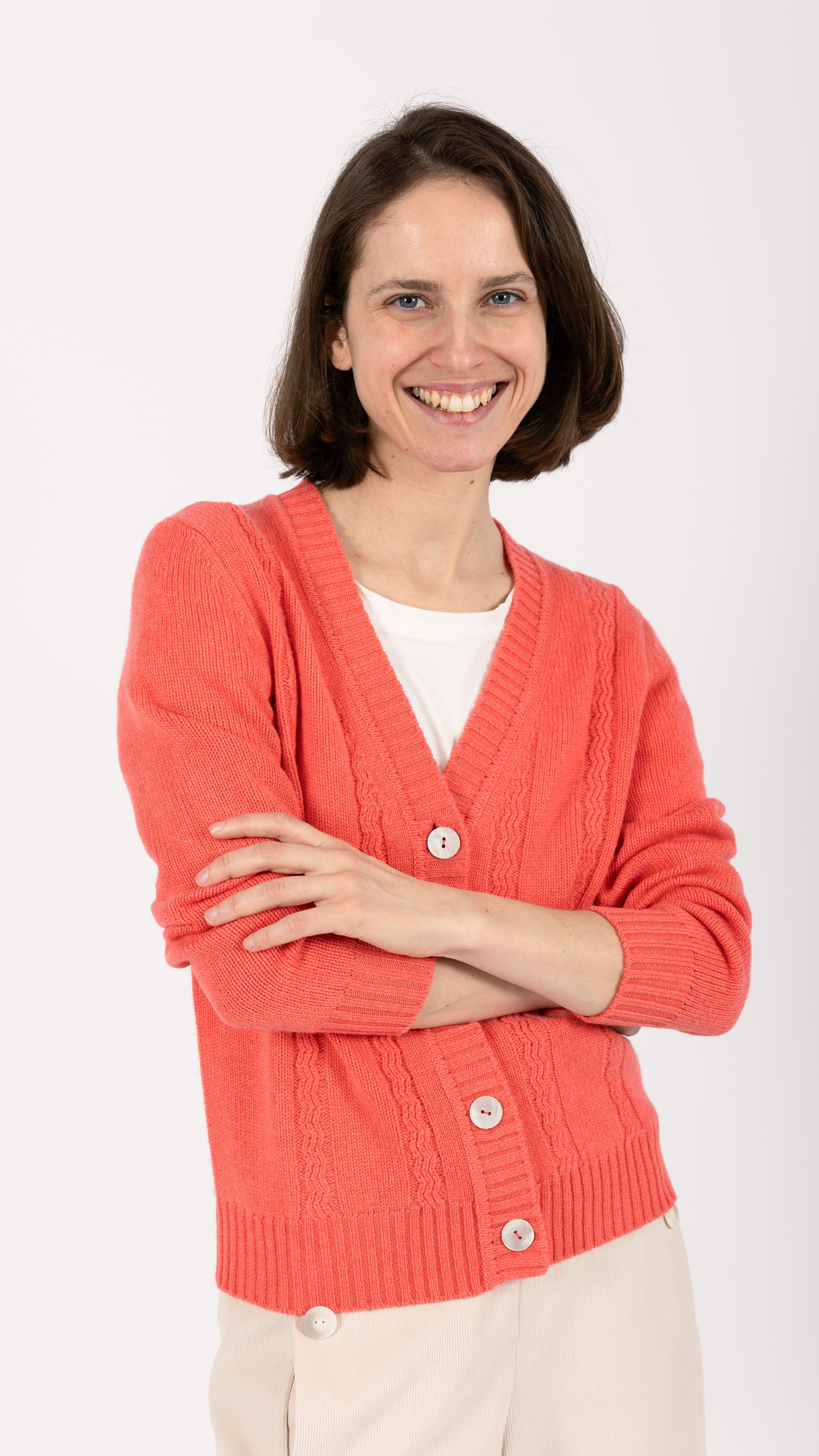 woman wearing VAAI coral cable knit cardigan