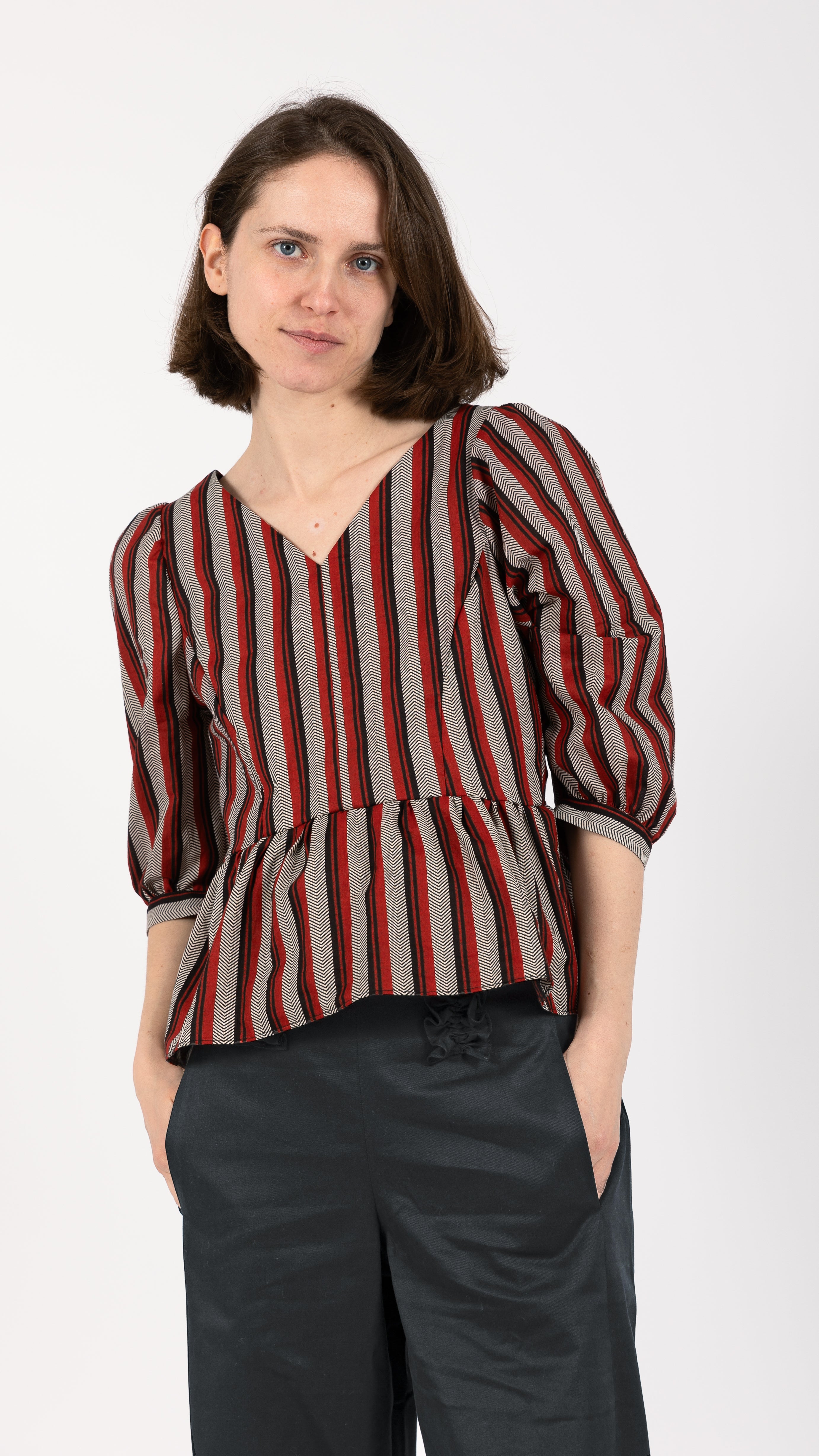 woman wearing VAAI striped cotton peplum top