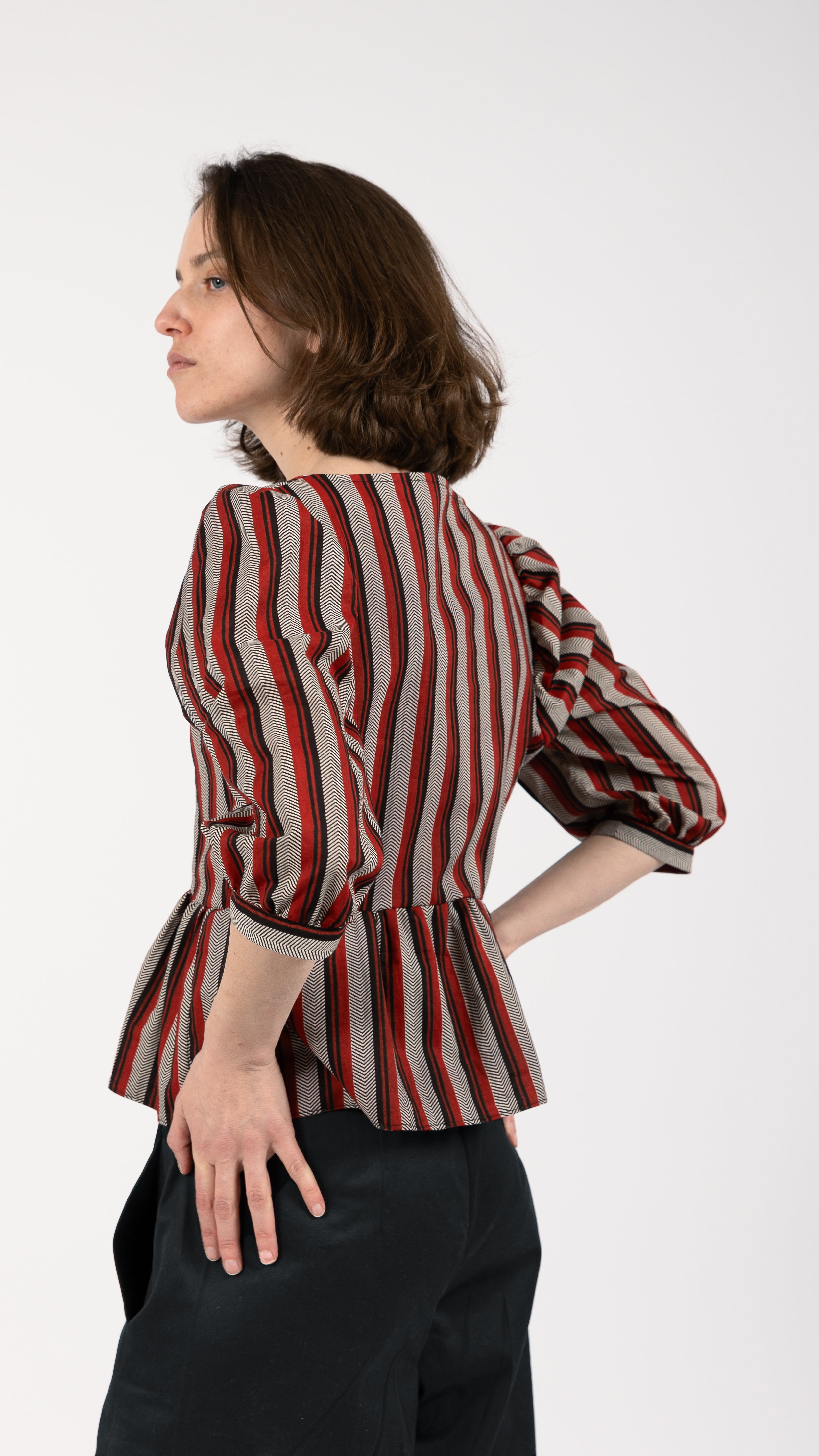 woman wearing VAAI striped cotton peplum top