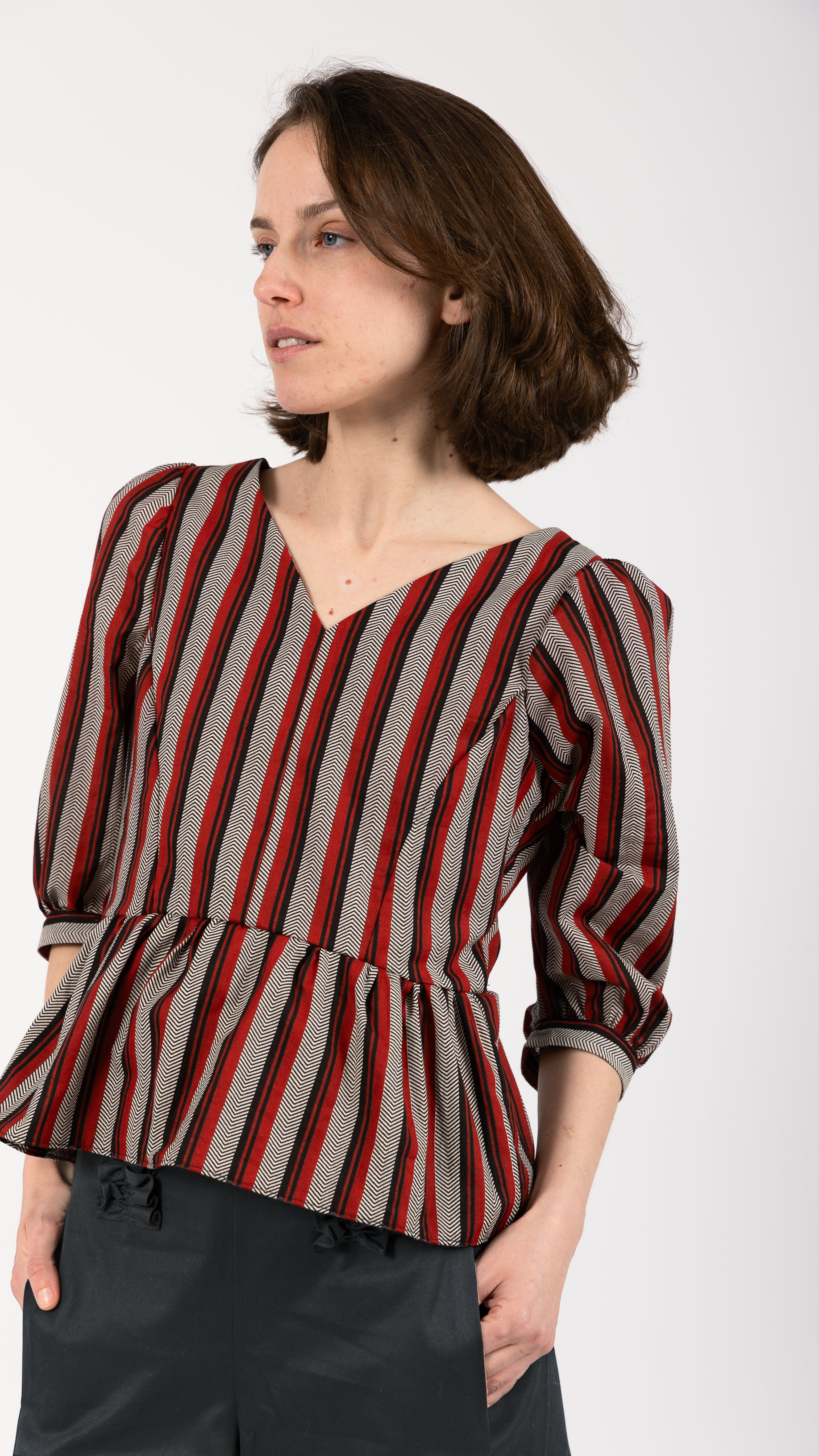 woman wearing VAAI striped cotton peplum top